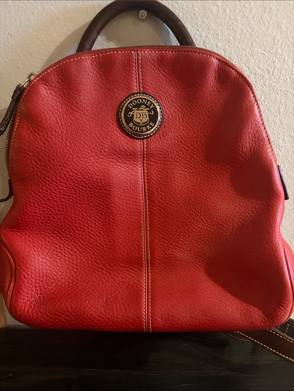 Dooney & Bourke Red Pebbled Leather Backpack with Logo Medallion